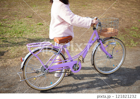 小学生の女の子が押している薄紫色の自転車。 小学生の女の子が押している薄紫色の自転車。 121821232