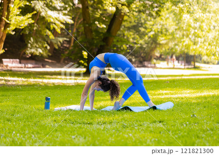 Flexible young woman doing yoga stretching exercises on mat, workout, gymnastic domestic fitness Flexible young woman doing yoga stretching exercises on mat, workout, gymnastic domestic fitness 121821300