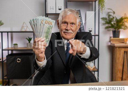Rich grandfather businessman working on laptop counting money cash, calculate profit at home office Rich grandfather businessman working on laptop counting money cash, calculate profit at home office 121821321
