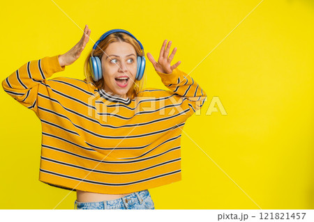 Happy woman listening music on headphones and dancing disco fooling around having fun Happy woman listening music on headphones and dancing disco fooling around having fun 121821457