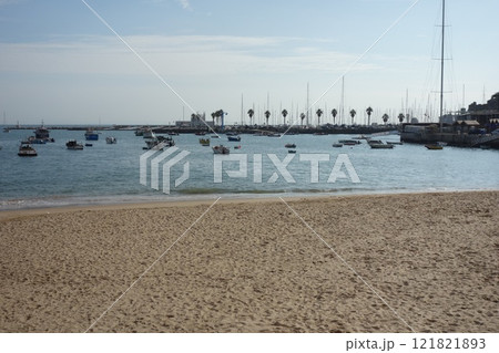 Portugal, Cascais seashore with a sandy beach and moored boats in the sea Portugal, Cascais seashore with a sandy beach and moored boats in the sea 121821893