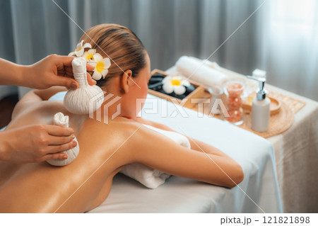 Hot herbal ball spa massage body treatment at day spa . Quiescent 121821898