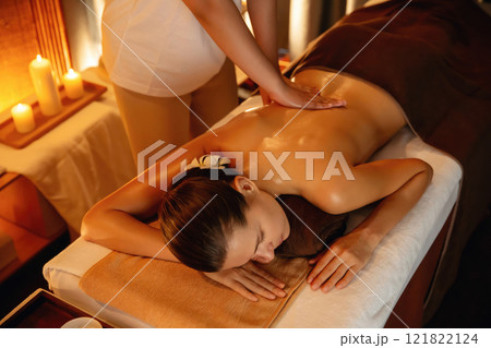 Caucasian woman customer enjoying relaxing anti-stress massage. Quiescent 121822124