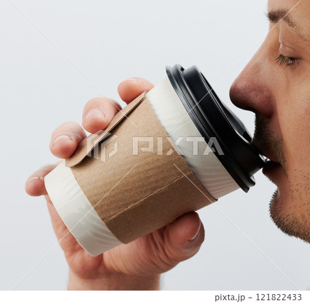 Drinking hot liquid from paper cup Drinking hot liquid from paper cup 121822433