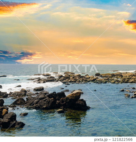 Seascape with beautiful waves, rocky shore and bright sunrise. Seascape with beautiful waves, rocky shore and bright sunrise. 121822566