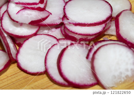 Chopped Up Sliced Radish on a Chopping Board in a Kitchen Chopped Up Sliced Radish on a Chopping Board in a Kitchen 121822650