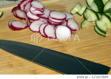 Chopped Up Sliced Radish on a Chopping Board in a Kitchen Chopped Up Sliced Radish on a Chopping Board in a Kitchen 121822660