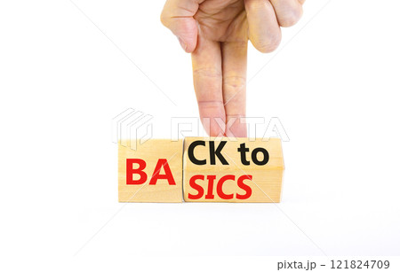 Back to basics symbol. Concept words Back to basics on wooden block. Beautiful white table white background. Businessman hand. Business back to basics concept. Copy space. 121824709