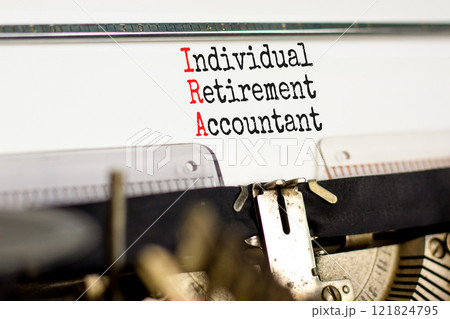 IRA individual retirement account symbol. Concept words IRA individual retirement account typed on retro typewriter. White background. Business IRA individual retirement account concept. Copy space IRA individual retirement account symbol. Concept words IRA individual retirement account typed on retro typewriter. White background. Business IRA individual retirement account concept. Copy space 121824795