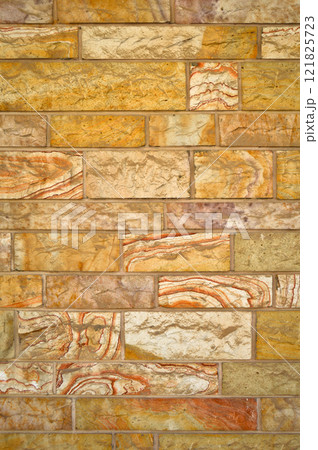 Sturdy yellow and beige cut stone wall, seamless lined up Sturdy yellow and beige cut stone wall, seamless lined up 121825723