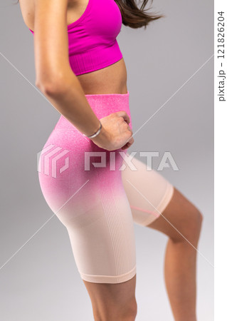 Closeup of Woman in Pink Sportswear, Fitness Attire, Stylish Workout Outfit, Athletic Clothing Concept Closeup of Woman in Pink Sportswear, Fitness Attire, Stylish Workout Outfit, Athletic Clothing Concept 121826204