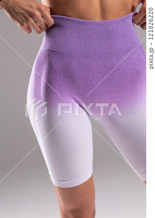 Closeup of purple ombre fitness shorts with high waist, focusing on texture, style, and fit, highlighting athletic fashion concept 121826220
