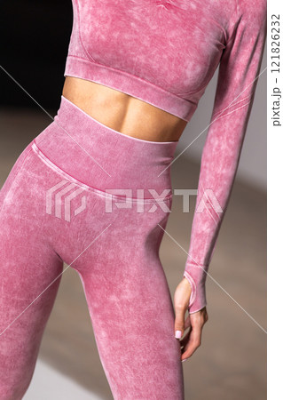 Sporty woman wearing pink seamless leggings and top, trendy activewear, fashion style in modern gym, fitness outfit concept 121826232