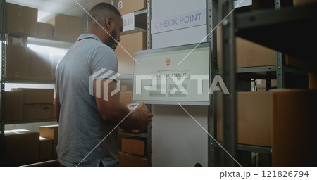 African American Warehouse Employee Scans Package at Postal Terminal with Digital Screen 121826794