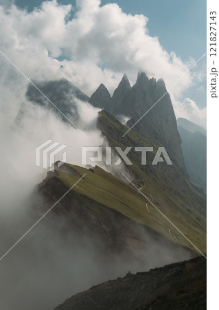 Experience the Breathtaking and Stunning View of Seceda in the Dolomites with its Striking Peaks and Misty Atmosphere 121827143