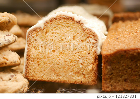 A Freshly Baked Loaf Cake Adorned with Icing and Accompanied by Cookies A Freshly Baked Loaf Cake Adorned with Icing and Accompanied by Cookies 121827831