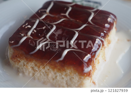 Delicious layered cake with fruit glaze and cream drizzle for dessert 121827939