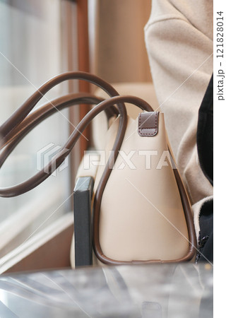 A Stylish and Elegant Handbag Placed on a Table Within a Cozy Setting 121828014