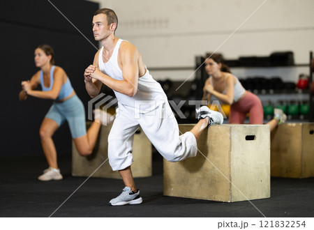 Athletic man in sportswear training his legs in gym Athletic man in sportswear training his legs in gym 121832254