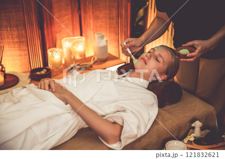 Woman indulges in rejuvenating with luxurious face cream spa massage. Quiescent 121832621