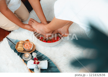 Man indulges in blissful foot massage at luxurious spa salon. Quiescent 121832636