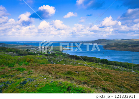 Donegal - A Picturesque Coastal Landscape featuring Calming Waters and Vibrant Lush Greenery all Donegal - A Picturesque Coastal Landscape featuring Calming Waters and Vibrant Lush Greenery all 121832911