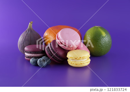 French macarons and fruits over purple background French macarons and fruits over purple background 121833724