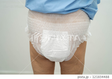 Asian senior woman patient wearing adult incontinence diaper pad in hospital. Asian senior woman patient wearing adult incontinence diaper pad in hospital. 121834488