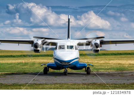 Front view of taxiing a turboprop passenger airplane at a rural airfield Front view of taxiing a turboprop passenger airplane at a rural airfield 121834978
