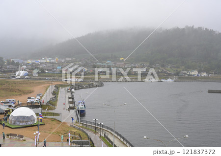 Lake Baikal embankment with boats near the village in thick fog Lake Baikal embankment with boats near the village in thick fog 121837372