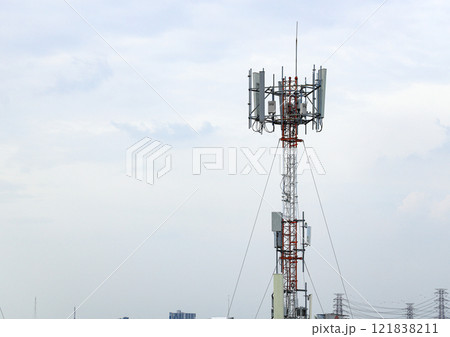 Wireless Communication Antenna pole, Mobile phone mast antenna pole on top of dilapidated building 121838211