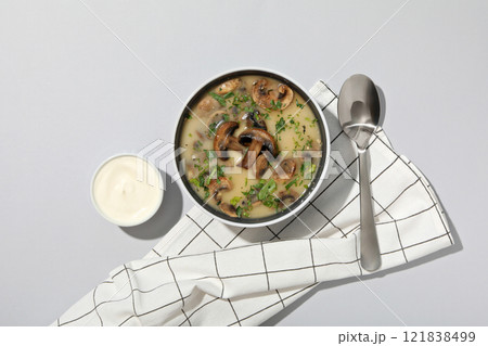 A bowl of cream of mushroom soup with sour cream 121838499