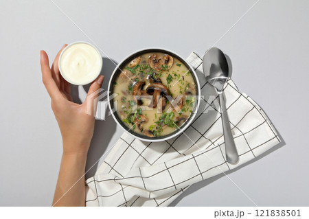 A bowl of cream of mushroom soup with sour cream A bowl of cream of mushroom soup with sour cream 121838501