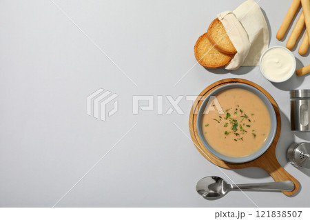 A bowl of cream of mushroom soup with croutons 121838507