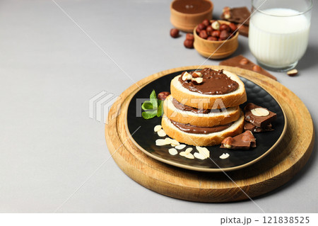 Bread with chocolate paste in a bowl on a gray background 121838525