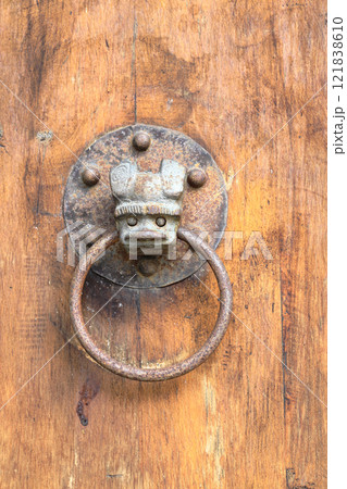 Vintage door knocker on old wooden door, antique knocker on a wooden door. Vintage door knocker on old wooden door, antique knocker on a wooden door. 121838610