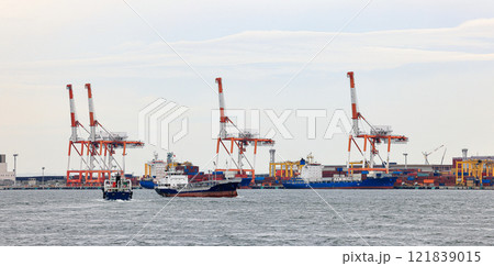 ConContainer port at Osaka Japan, contatainer port at Osaka Japan, container crane at Industrial port for cargo container ship. Cargo transportation and activity at modern shipping container terminal. 121839015