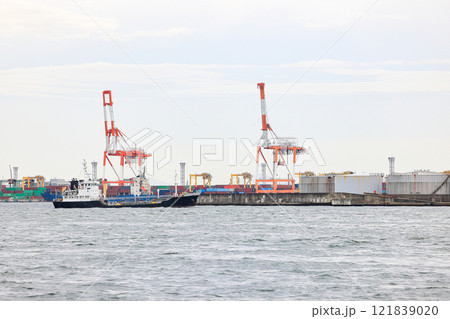 Container port at Osaka Japan, container crane at Industrial port for cargo container ship. Cargo transportation and activity at modern shipping container terminal. 121839020