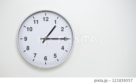 Minimalist White Clock with Silver Frame Striking 13.15/01.15 on White Background. Perfect for Time Management and Corporate Campaigns Minimalist White Clock with Silver Frame Striking 13.15/01.15 on White Background. Perfect for Time Management and Corporate Campaigns 121839357