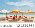 Woman sit on the orange umbrella chair set on the beach with blue sky. 121839862