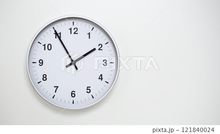 Minimalist White Clock with Silver Frame Striking 13.55/01.55 on White Background. Perfect for Time Management and Corporate Campaigns Minimalist White Clock with Silver Frame Striking 13.55/01.55 on White Background. Perfect for Time Management and Corporate Campaigns 121840024