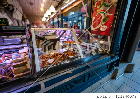 Budapest, Hungary. August 29,2022. The covered market, detail of a stall of a vendor of processed meats and cured meats. The various cuts are displayed with the tag with type and price. Budapest, Hungary. August 29,2022. The covered market, detail of a stall of a vendor of processed meats and cured meats. The various cuts are displayed with the tag with type and price. 121840078