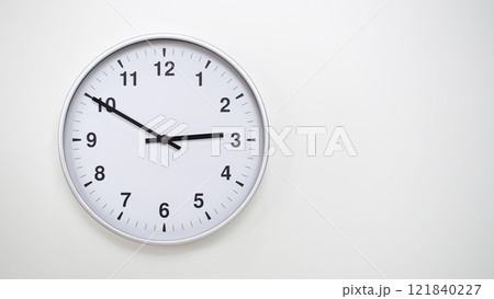 Minimalist White Clock with Silver Frame Striking 14.50/02.50 on White Background. Perfect for Time Management and Corporate Campaigns Minimalist White Clock with Silver Frame Striking 14.50/02.50 on White Background. Perfect for Time Management and Corporate Campaigns 121840227