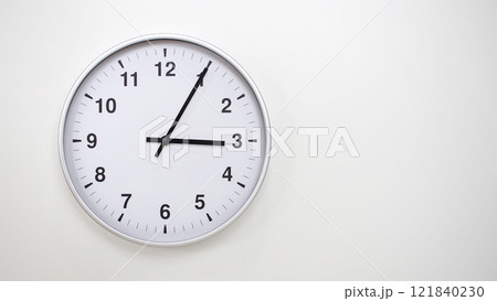 Minimalist White Clock with Silver Frame Striking 15.05/03.05 on White Background. Perfect for Time Management and Corporate Campaigns Minimalist White Clock with Silver Frame Striking 15.05/03.05 on White Background. Perfect for Time Management and Corporate Campaigns 121840230