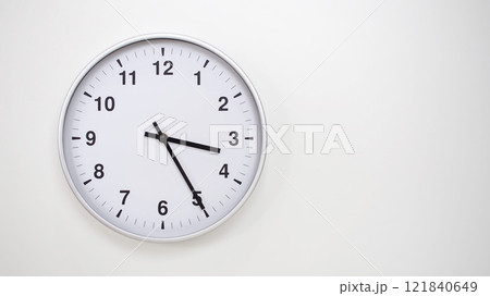 Minimalist White Clock with Silver Frame Striking 15.25/03.25 on White Background. Perfect for Time Management and Corporate Campaigns Minimalist White Clock with Silver Frame Striking 15.25/03.25 on White Background. Perfect for Time Management and Corporate Campaigns 121840649