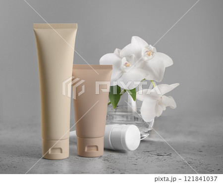 Tubes tonal foundation makeup mockup Featuring Fresh Orchids Set Against a Gray Background 121841037