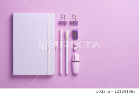 Minimalist pastel stationery flatlay with notepad and office supplies pen, pencil, marker, clips, pins and sharpener on lilac background. Space for your text. Minimalist pastel stationery flatlay with notepad and office supplies pen, pencil, marker, clips, pins and sharpener on lilac background. Space for your text. 121841668