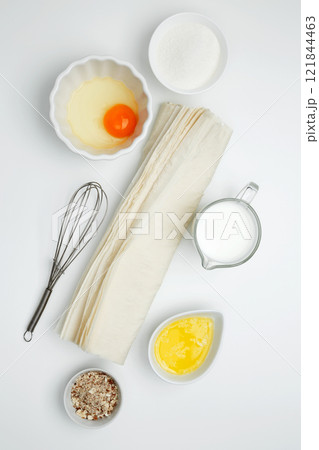 Baking Crinkle Cake ingredients, phyllo dough, egg, butter, nuts, milk 121844463