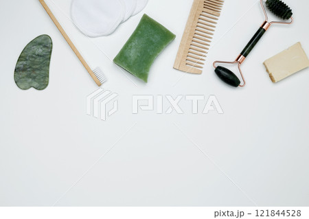 Eco-friendly beauty essentials, including bamboo toothbrush, marble face roller, embodying a sustainable self-care concept Eco-friendly beauty essentials, including bamboo toothbrush, marble face roller, embodying a sustainable self-care concept 121844528