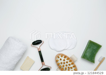 Eco-friendly beauty products: massage brush, marble roller, towel, reusable cotton pads, sustainable self-care concept 121844529